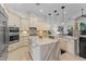 Bright kitchen featuring custom cabinets, marble countertops, and stainless steel appliances at 3340 Fernlake Pl, Longwood, FL 32779