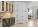 Kitchen featuring custom cabinets, marble countertops, wine refrigerators, and tile flooring at 3340 Fernlake Pl, Longwood, FL 32779