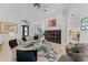 Bright living room with fireplace, tile flooring, and views into the dining room and entryway at 3340 Fernlake Pl, Longwood, FL 32779