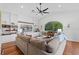 Bright living room with hardwood floors, built-in shelves, a large sofa and natural light at 3340 Fernlake Pl, Longwood, FL 32779