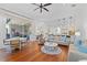 Bright open-concept living room with hardwood floors, neutral decor, and seamless flow to the outdoor space at 3340 Fernlake Pl, Longwood, FL 32779