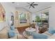 Bright living room with hardwood floors, ceiling fan, and built-in shelves with a view of the pool at 3340 Fernlake Pl, Longwood, FL 32779
