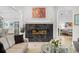 Elegant living room boasts a black tile fireplace, neutral sofa, and artistic decor at 3340 Fernlake Pl, Longwood, FL 32779