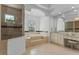 Elegant main bathroom featuring a soaking tub, glass shower, and vanity with ample storage at 3340 Fernlake Pl, Longwood, FL 32779
