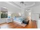Bright bedroom with hardwood floors, tray ceilings, and large windows offering abundant natural light at 3340 Fernlake Pl, Longwood, FL 32779