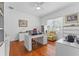 Bright office with a ceiling fan, hardwood floors, large desk, and a yellow chair at 3340 Fernlake Pl, Longwood, FL 32779