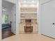 Bright office nook boasts built-in shelving with stone accent and a stylish chair at 3340 Fernlake Pl, Longwood, FL 32779