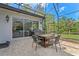 Outdoor dining area on the patio with outdoor grill and furniture, sliding glass door and grassy yard at 3340 Fernlake Pl, Longwood, FL 32779