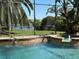 Poolside view showcasing the pristine pool, lush backyard, and serene waterfront view at 3340 Fernlake Pl, Longwood, FL 32779