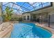 A sparkling pool and spa with safety fence are enclosed in a screened lanai at 3340 Fernlake Pl, Longwood, FL 32779
