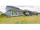 Well-maintained backyard with lush green lawn, mature landscaping and a view of the home's rear exterior at 345 Aquamarine Way, Daytona Beach, FL 32124