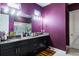 Modern bathroom with double vanity, granite countertops, a large mirror, and stylish lighting at 345 Aquamarine Way, Daytona Beach, FL 32124