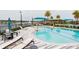 Beautiful community pool featuring sun loungers, an umbrella, and landscaped surroundings at 345 Aquamarine Way, Daytona Beach, FL 32124
