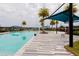Inviting community pool featuring a blue sunshade structure and comfortable lounge chairs at 345 Aquamarine Way, Daytona Beach, FL 32124