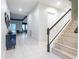 Spacious foyer with tiled floors, staircase, and contemporary decor leading to the main living areas at 345 Aquamarine Way, Daytona Beach, FL 32124