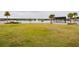 Expansive lawn area facing the lake with a fountain and shelter with a stone fireplace at 345 Aquamarine Way, Daytona Beach, FL 32124