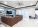 Living room features an accent wall, large sofa, ceiling fan, and tile floors throughout at 345 Aquamarine Way, Daytona Beach, FL 32124