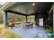 Covered outdoor patio featuring dining table, grill, hammock and views of the surrounding landscape at 345 Aquamarine Way, Daytona Beach, FL 32124