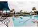 A stunning swimming pool with lounge seating and lovely landscaping in a beautiful community at 345 Aquamarine Way, Daytona Beach, FL 32124