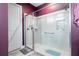 Bathroom shower with glass doors, tiled walls, grab bar, and a built-in soap and shampoo niche at 345 Aquamarine Way, Daytona Beach, FL 32124