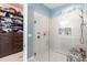 Modern bathroom shower with glass door, tiled walls, a rain shower head, and a built-in shelf at 345 Aquamarine Way, Daytona Beach, FL 32124