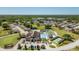 Aerial view of community amenities including a clubhouse, swimming pool, and tennis courts, nestled in lush greenery at 3748 Innisbrook Dr, Lakeland, FL 33810