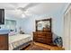 Bedroom featuring light blue walls, ceiling fan, closet, and wood floors at 3748 Innisbrook Dr, Lakeland, FL 33810
