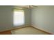 Bright bedroom features neutral walls, a ceiling fan, wood floors, and a window with sheer curtains at 3748 Innisbrook Dr, Lakeland, FL 33810