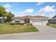 Charming single-story home with manicured lawn, mature landscaping, and a two-car garage at 3748 Innisbrook Dr, Lakeland, FL 33810