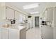 Functional kitchen with white cabinetry, tile flooring, and efficient layout at 3748 Innisbrook Dr, Lakeland, FL 33810