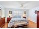 Bright main bedroom with a large bed, wood floors, dresser with mirror and natural light at 3748 Innisbrook Dr, Lakeland, FL 33810