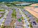 Aerial view of the neighborhood, showcasing nearby lake and green spaces at 434 Ironside Trail Dr, Groveland, FL 34736