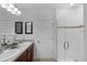 Modern bathroom featuring double sinks and a glass enclosed walk in shower at 434 Ironside Trail Dr, Groveland, FL 34736