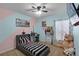 Bedroom featuring a dual-colored wall, a large bed, and a window with curtains at 434 Ironside Trail Dr, Groveland, FL 34736