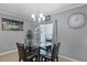 A charming dining area featuring a chandelier and an adjacent kitchen at 434 Ironside Trail Dr, Groveland, FL 34736