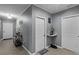 Hallway featuring neutral paint, doors, and tile floors, with table and decorations at 434 Ironside Trail Dr, Groveland, FL 34736