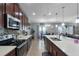 A spacious kitchen with quartz countertops, stainless steel appliances, and eat in dining area at 434 Ironside Trail Dr, Groveland, FL 34736