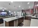 Open-concept kitchen with a large island and seating, stainless steel appliances, and views of the living area at 434 Ironside Trail Dr, Groveland, FL 34736