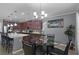 Bright kitchen featuring stainless steel appliances, quartz countertops, and an adjacent dining area at 434 Ironside Trail Dr, Groveland, FL 34736