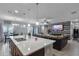 Open-concept kitchen with island seating and views into the dining and living areas at 434 Ironside Trail Dr, Groveland, FL 34736