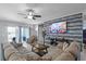 Comfortable living room featuring a sectional sofa, modern TV, and sliding glass doors at 434 Ironside Trail Dr, Groveland, FL 34736