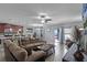 Open-concept living room, kitchen and dining area with modern lighting and lots of space at 434 Ironside Trail Dr, Groveland, FL 34736