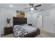 Well-lit main bedroom featuring a ceiling fan and an adjacent bathroom at 434 Ironside Trail Dr, Groveland, FL 34736