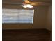 Cozy bedroom with large window and neutral walls with ceiling fan at 4350 Perkinshire Ln # 108, Orlando, FL 32822