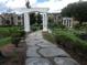 Landscaped community grounds with pathways, ponds, arbors, and mature trees and shrubs at 4350 Perkinshire Ln # 108, Orlando, FL 32822