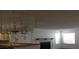 Bright living room with large chandelier, fireplace, and an open view of the kitchen at 4350 Perkinshire Ln # 108, Orlando, FL 32822
