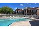Sparkling pool with lounge chairs and tables surrounded by white picket fence at 4350 Perkinshire Ln # 108, Orlando, FL 32822