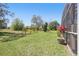 A lawn space with scattered trees adds the perfect outdoor experience to this home at 442 Troon Cir, Davenport, FL 33897