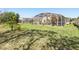 This lovely lawn space in the backyard offers an expansive space to enjoy the Florida sunshine at 442 Troon Cir, Davenport, FL 33897