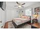 Comfortable bedroom features wood floors, a ceiling fan and a large closet for storage at 442 Troon Cir, Davenport, FL 33897